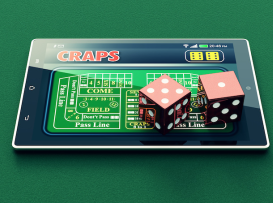 Mesa de craps digital num tablet com dois dados vermelhos sobre pano verde de casino