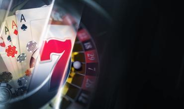 Composição de elementos de casino: cartas de baralho, fichas, símbolo sete de slot e roda de roleta